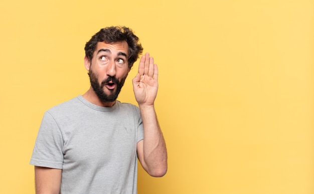 Young crazy bearded man surprised expression