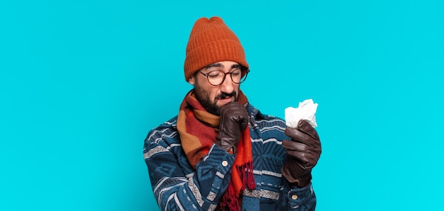 Young crazy bearded man and wearing winter clothes. illness concept