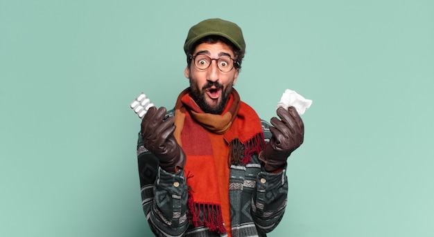 Young crazy bearded man and wearing winter clothes. illness concept