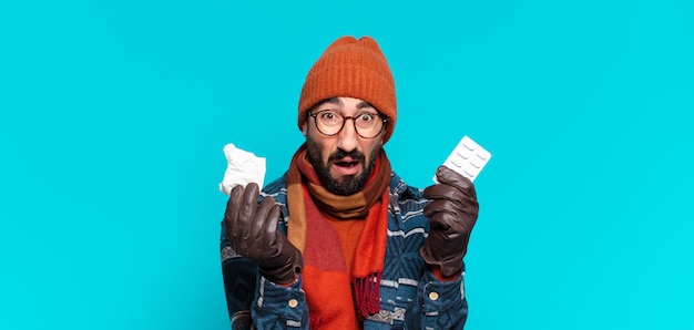 Photo young crazy bearded man and wearing winter clothes. illness concept