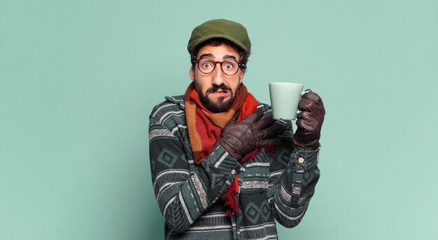 Young crazy bearded man and wearing winter clothes