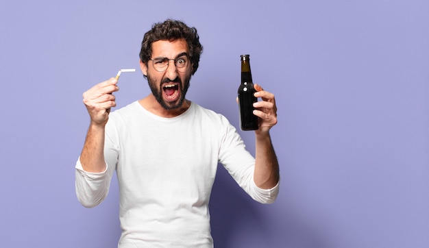 Young crazy bearded man with a beer