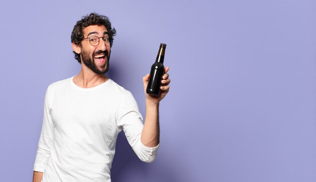 Young crazy bearded man with a beer