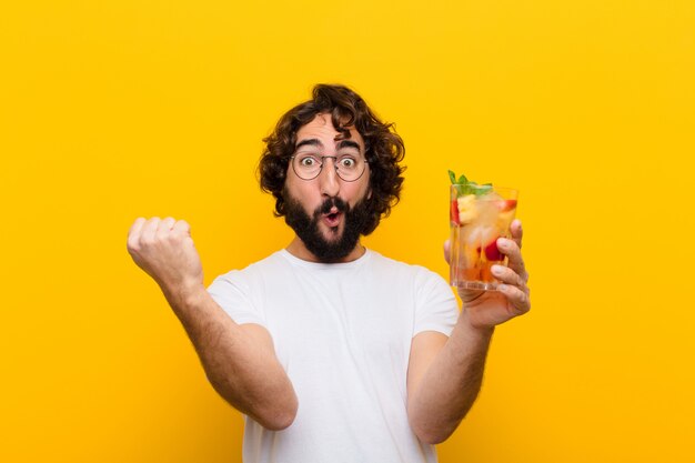 Young crazy bearded man with a cocktail. tourist concept