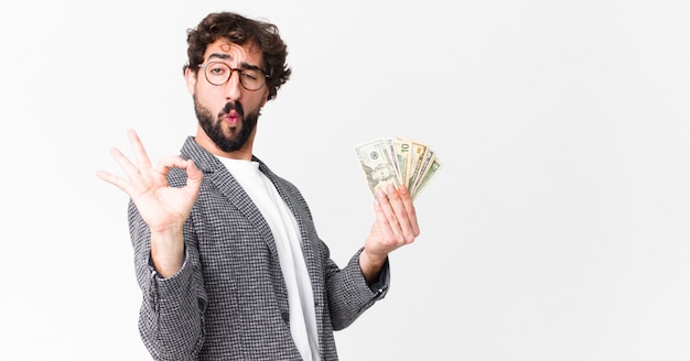 Young crazy bearded man with dollar banknotes