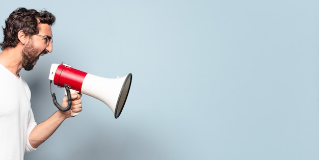 Young crazy bearded man with a megaphone