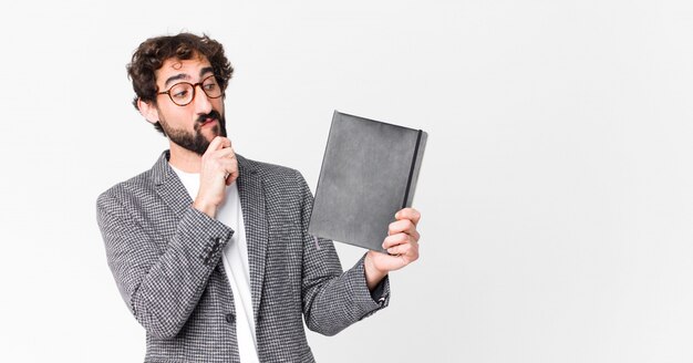 Young crazy bearded man with a notebook