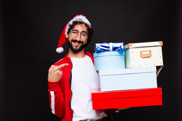 Young crazy bearded man with santa hat. Christmas concept