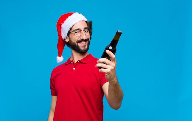 Young crazy bearded man with santa hat. Christmas concept