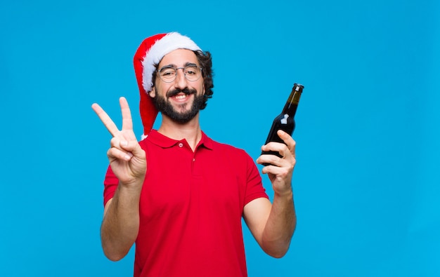 Young crazy bearded man with santa hat. Christmas concept