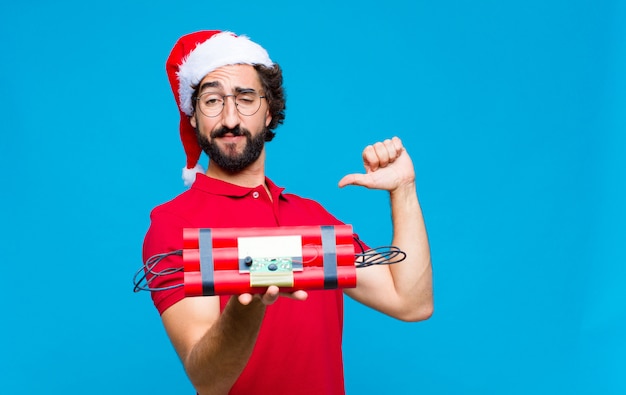 Young crazy bearded man with santa hat. Christmas concept