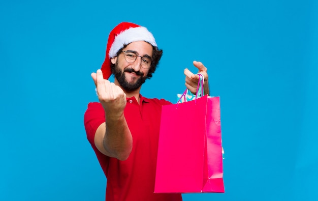 Young crazy bearded man with santa hat. Christmas concept