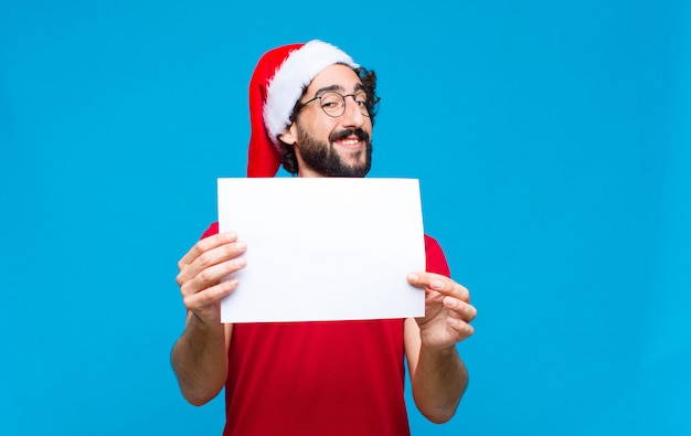 Young crazy bearded man with santa hat. Christmas concept