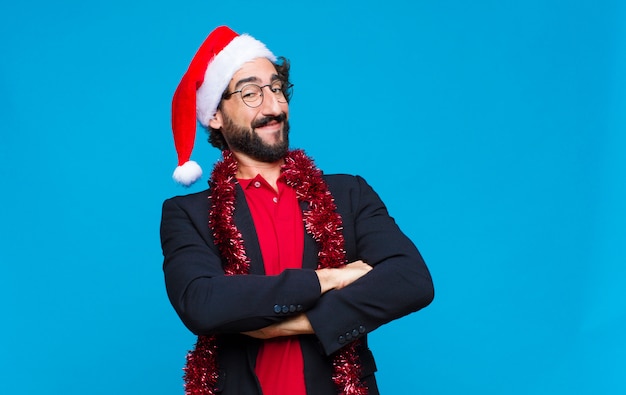 Young crazy bearded man with santa hat. Christmas concept