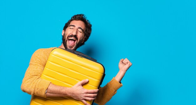 Young crazy bearded man with a suit case