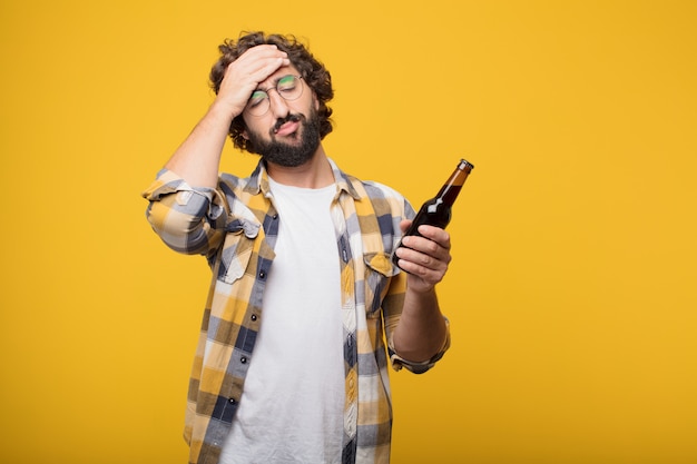 Young crazy mad man  fool pose with a beer bottle.