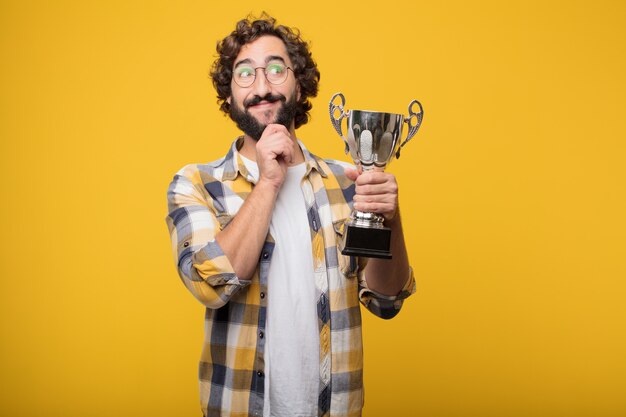 Young crazy mad man  fool pose with a trophy.