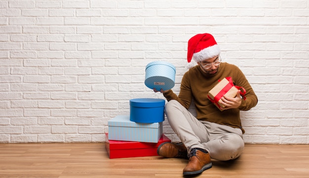 Young crazy man celebrating christmas in his house