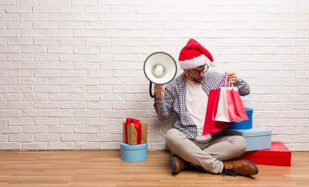 Young crazy man celebrating christmas in his house