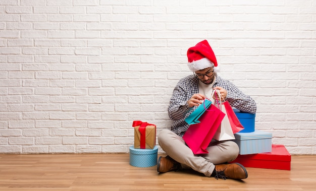 Young crazy man celebrating christmas in his house