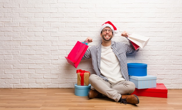 Young crazy man celebrating christmas in his house