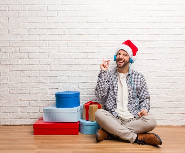 Young crazy man celebrating christmas in his house