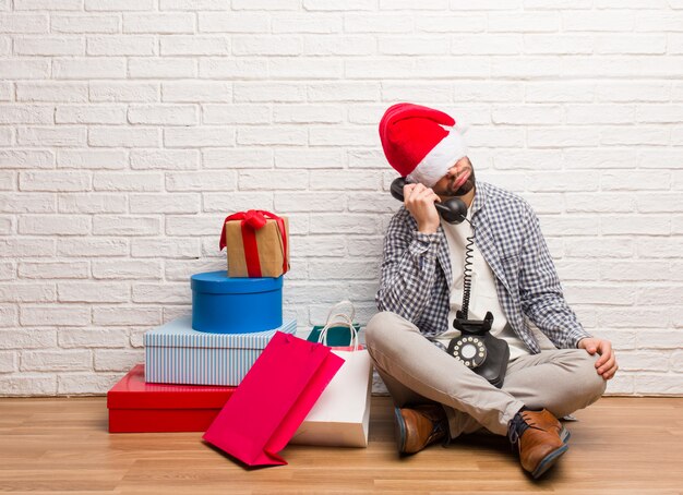 Young crazy man celebrating christmas in his house