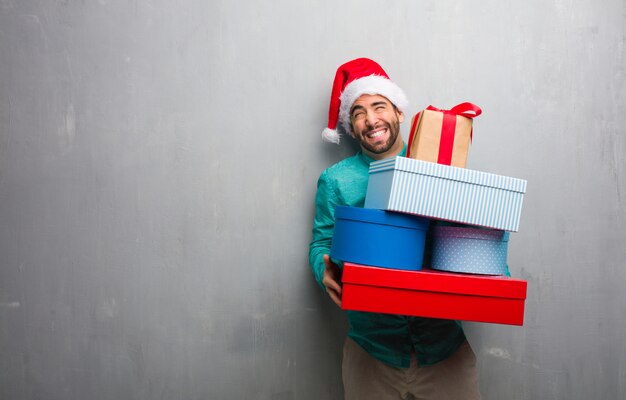 Young crazy man holding gifts celebrating christmas