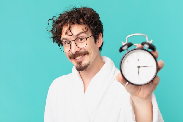 Young crazy man with an alarm clock