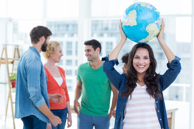 Young creative business people with a globe