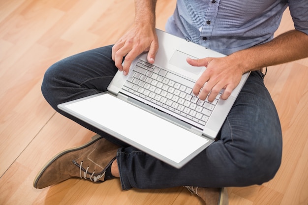 Young creative businessman working on laptop