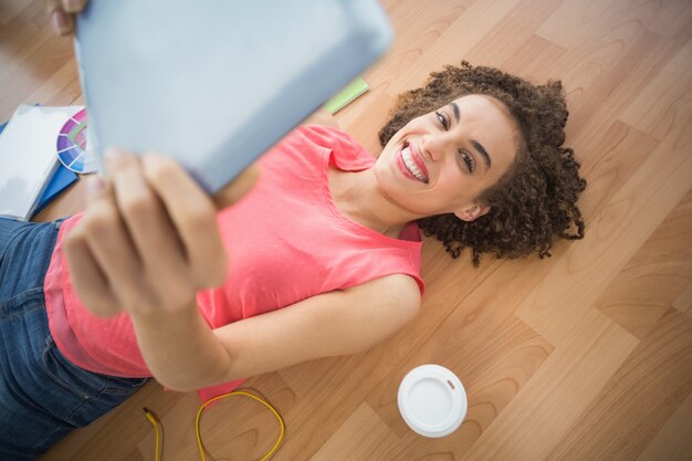 Young creative businesswoman taking a selfie