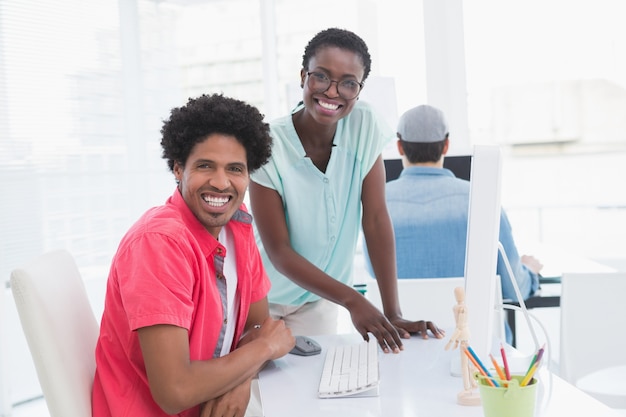 Young creative team speaking at desk