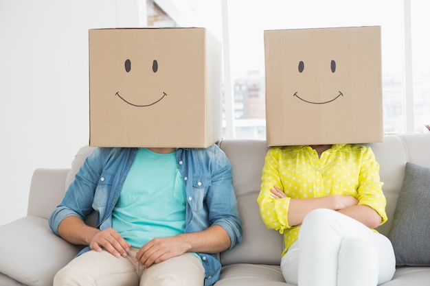 Photo young creative team wearing boxes on head