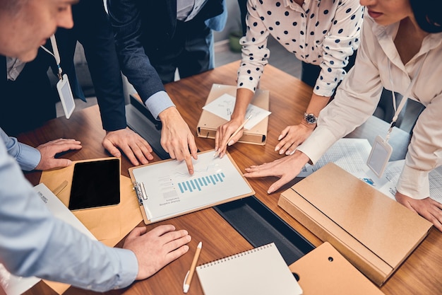 Young crew of caucasian business people communicating in office company