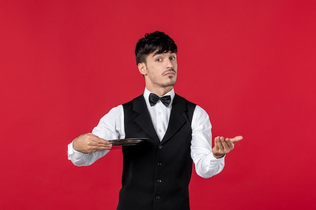 young curious man waiter in a uniform