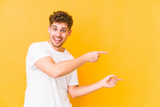 young curly blond man pointing to side