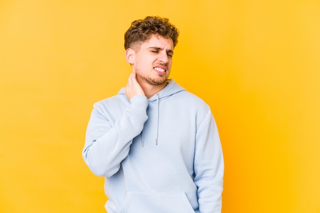 young curly blond man suffering a neck pain