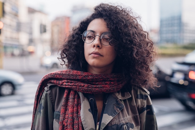 Young and curly girl in the street