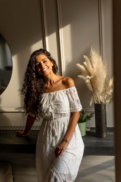 Young curly hair woman standing in the room