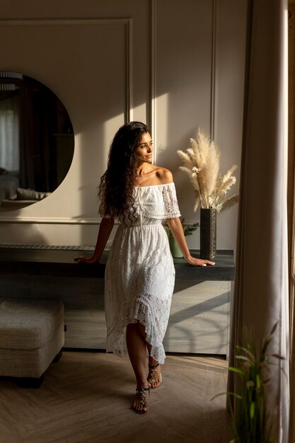 Young curly hair woman standing in the room