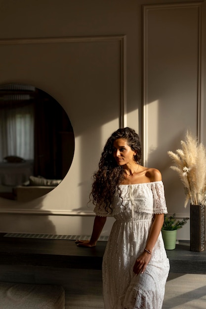 Young curly hair woman standing in the room