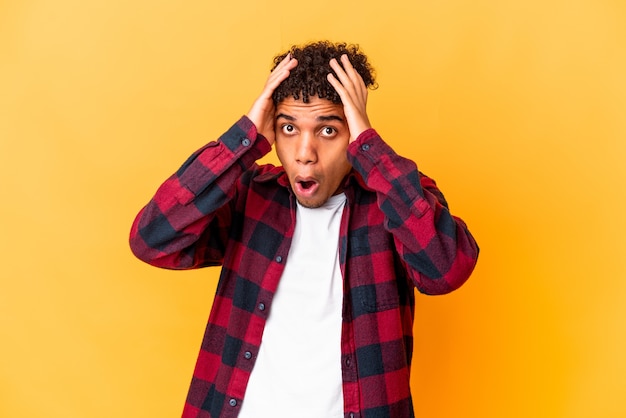 Young curly man isolated being shocked, she has remembered important meeting