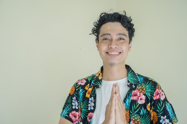 Young curly man wear beachwear with greeting pose