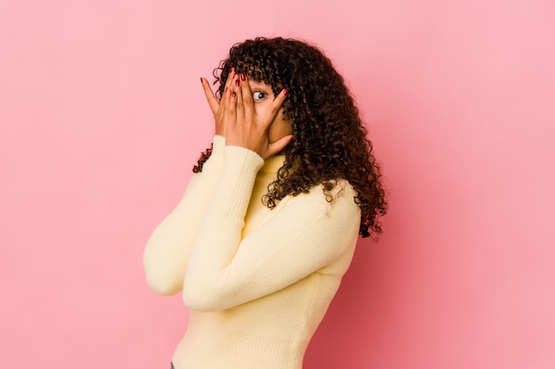 Young curly woman expressing emotions isolated