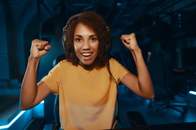 Young curly woman playing cyber games