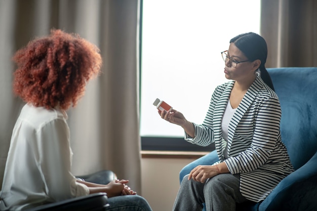 Young curly woman talking to her psychotherapist