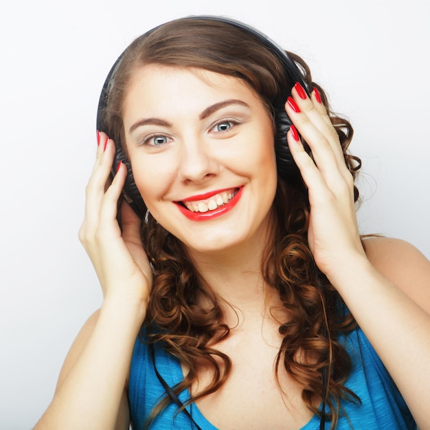 Young curly woman with headphones listening music