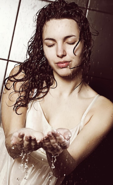 Young curly woman with water