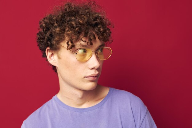 Young curlyhaired man posing emotions closeup isolated background